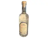 Eine Flasche Ouzo mit korken. Der Etikett beschreibt den Ouzo Geschmack und die Geschichte des Getränks.