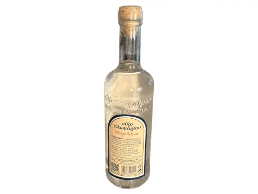 Eine Flasche Ouzo mit korken. Der Etikett beschreibt den Ouzo Geschmack und die Geschichte des Getränks.